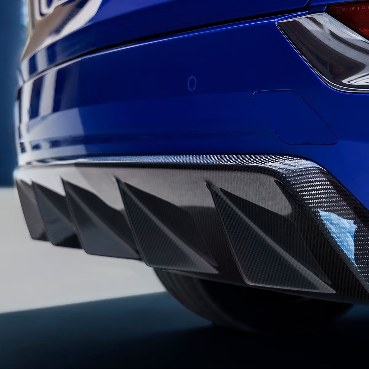 Carbon fiber rear diffuser on a blue 2027 Cadillac OPTIQ-V