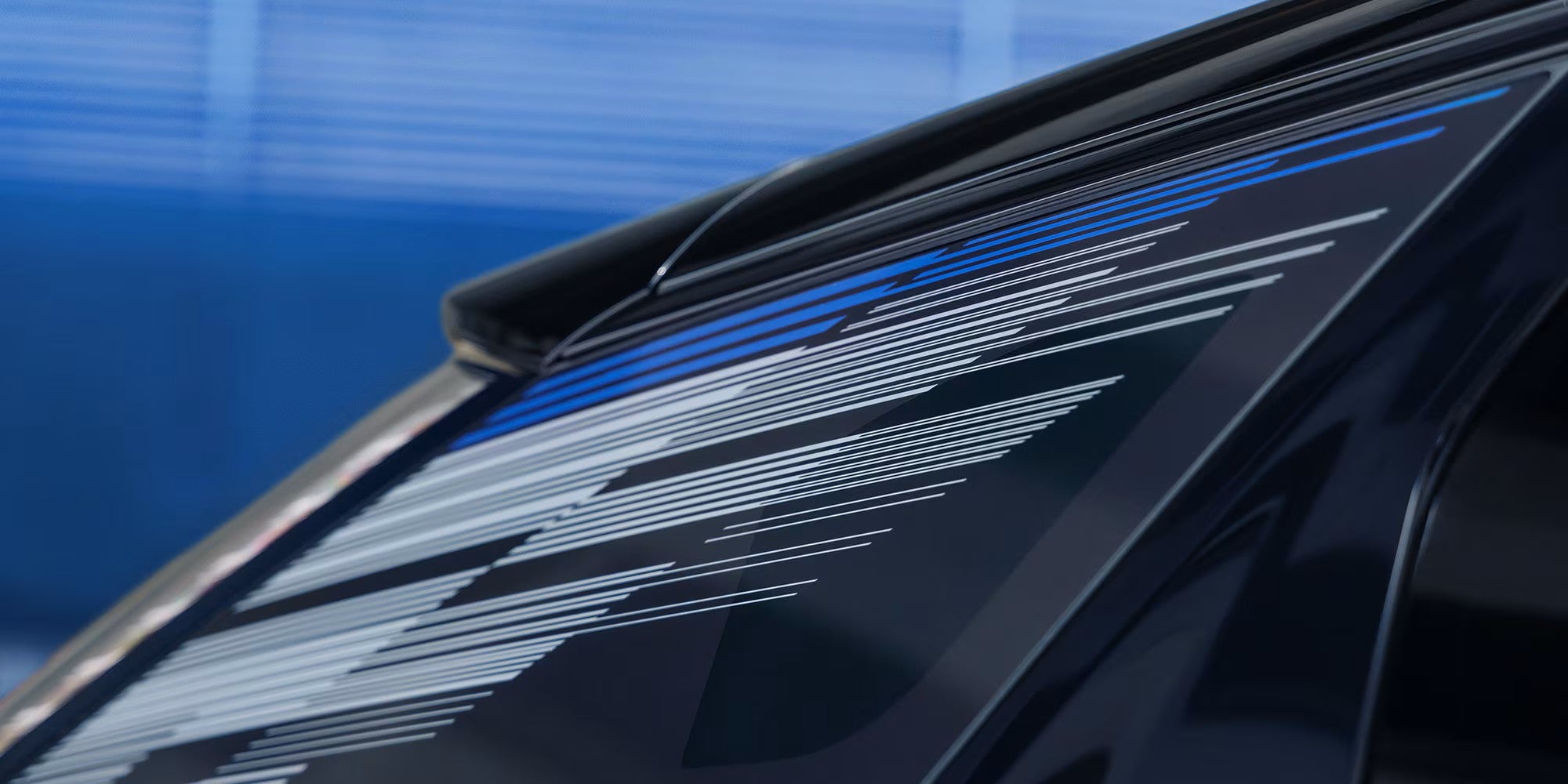 Mondrian line pattern on the rear quarter glass of a 2027 Cadillac OPTIQ-V